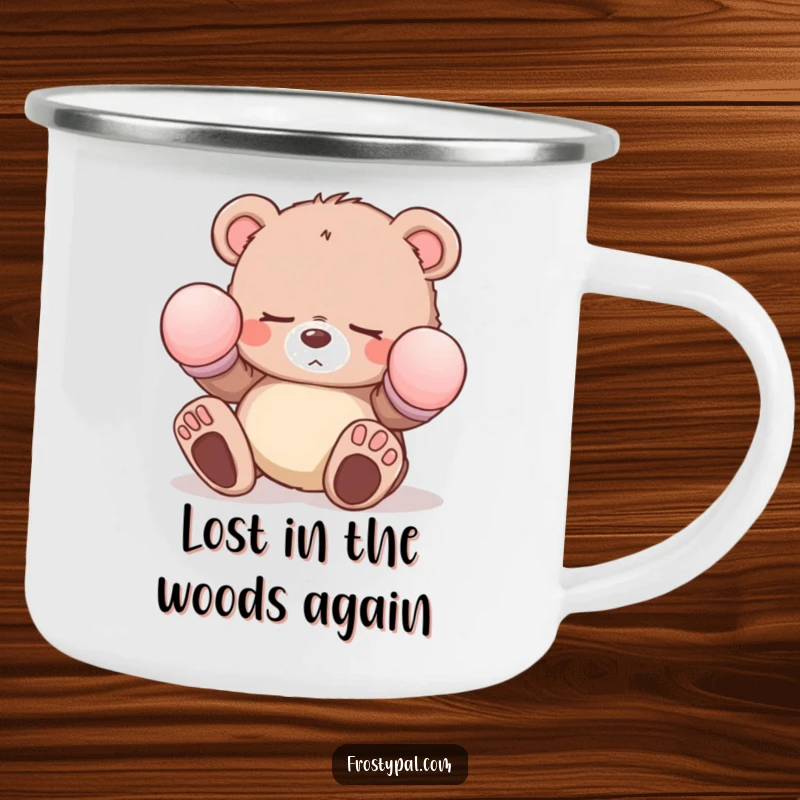 Funny sleepy bear cub camping mug with oversized mittens tripping, depicting a comical character for humorous outdoor drinkware.